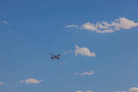 Beautiful view of aircraft in blue sky with rare white clouds.の写真素材