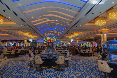 Beautiful view of interior of casino in hotel with people playing slot machines. Las Vegas. USA. 04.25.2023.のeditorial素材