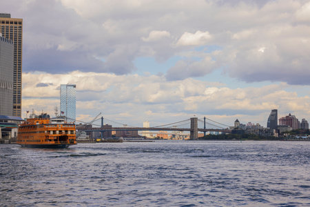 Beautiful landscape view with Brooklyn Bridge with cruise ship on background. New York, USA. 09.21.2022.のeditorial素材