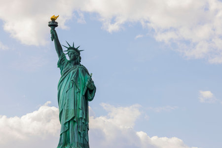 Beautiful view of Statue of Liberty on Liberty island in New York against blue sky with white clouds.の写真素材