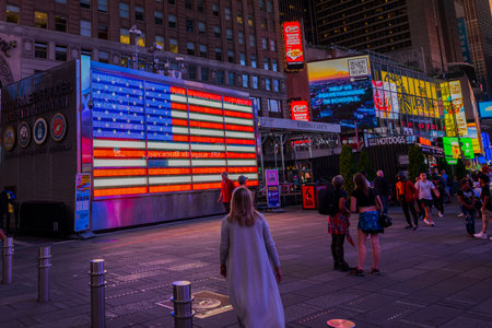 Beautiful night view of Times Square in Manhattan at military recruiting station square against backdrop of American flag. New York. USA. 09.22.2022.のeditorial素材