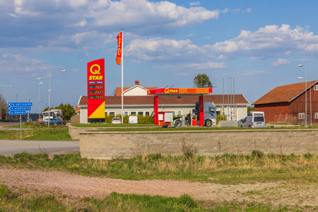 View of self service Q star gasoline station on blue sky background. Sweden. Europe.のeditorial素材