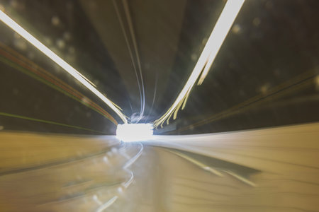Beautiful view of exit from tunnel with defocused colorful tracers of road lights. Abstract backgrounds. Sweden. Stockholmの写真素材