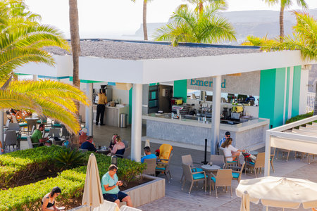 View of hotel guests in outdoor pool restaurant on hot summer day. Gran Canaria, Spain.のeditorial素材