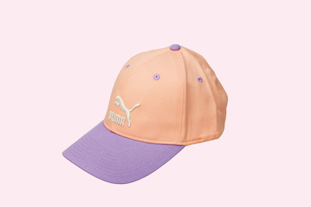 Close-up of pink Puma baseball cap isolated on pink background.のeditorial素材