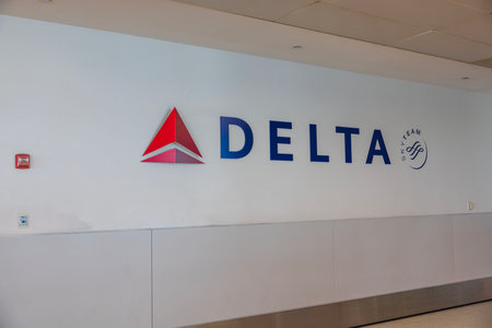 Close-up view of Delta logo on white wall background. USA. NY.のeditorial素材