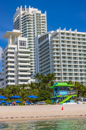 View of people on beach near high buildings on hot summer day. Miami Beach, Florida, USA.のeditorial素材