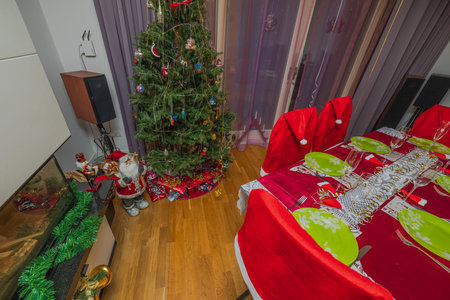 Beautiful top view interior of room with Christmas tree decoration and served table. Sweden.の写真素材