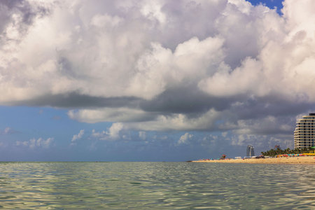 Beautiful view of Atlantic Ocean and Miami Beach coastline under havy white clouds on blue sky.の写真素材