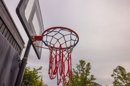 Close-up view of basketball hoop on  cloudy sky background. Sweden.