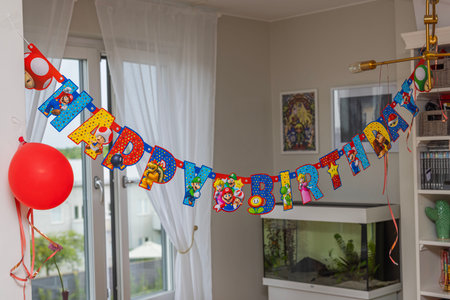 Interior view of room decorated with colorful Happy Birthday letters.のeditorial素材