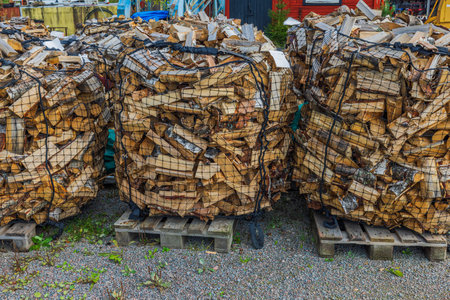 Close-up view of birch firewood in transport bags.の写真素材