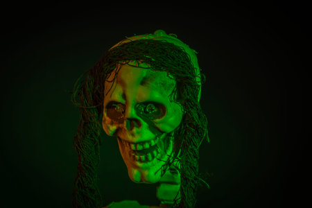Close up view of green illuminated skeleton head on black background. Halloween concept.の写真素材