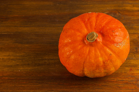 Close up view of pumpkin isolated on wooden background.の写真素材