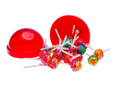 Close up view of open big plastic chupa chups package  several caramels isolated on white background.のeditorial素材