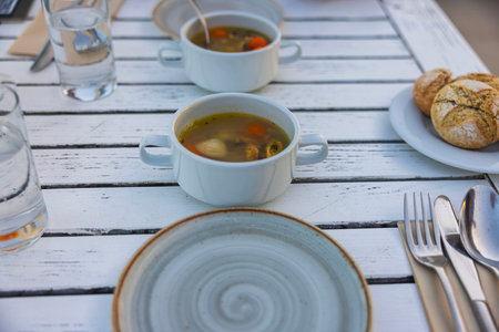 View of food plates on white wooden table. Eating out concept.の写真素材