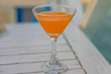 Close-up of glass of alcoholic drink in restaurant on white table.の写真素材