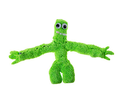 Close-up view of cute, handmade toy crafted by child from green foam clay.の写真素材