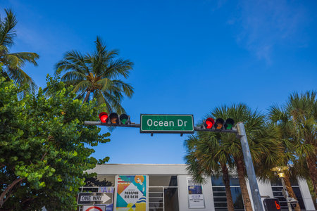 Close-up view of red traffic light and road sign for Ocean Drive in Miami Beach. USAのeditorial素材