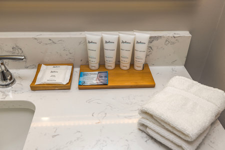 Interior view hotel bathroom. Towels and bathroom essentials for comfortable stay. Miami Beach.のeditorial素材