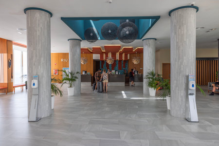 View of hotel lobby with reception area where tourists check in for rooms accommodation. Gran Canaria, Spain.のeditorial素材