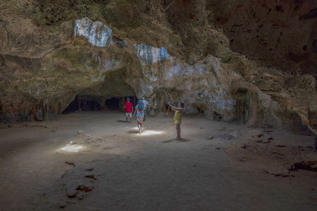Captivating scene of Quadirikiri Caves in Arikok National Park on island of Aruba, with tourists examining cavernous wonders. Oranjestad. Aruba.のeditorial素材
