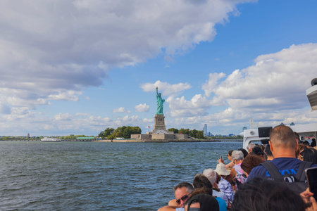 Boat tour on Hudson River showcasing landmarks like Statue of Liberty with tourists aboard. New York. USA.のeditorial素材