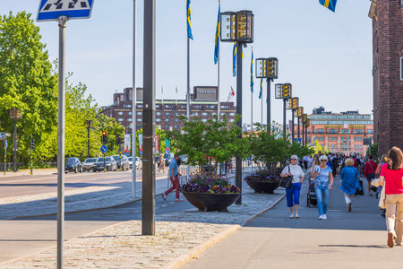 View of people strolling through center of Stockholm on historic buildings and cloudless blue sky background. Sweden. Stockholm.のeditorial素材