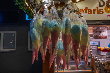 Close-up view of cellophane-wrapped balls with multicolored cotton candy for attracting shoppers.