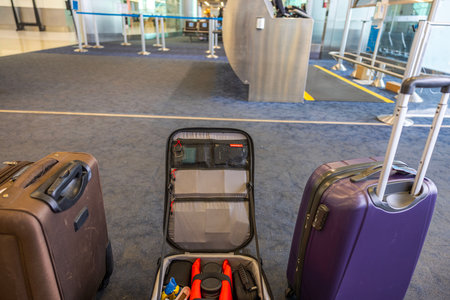 Close-up view of hand luggage at the airport with an open suitcase for photographic equipment. Miami. USA.のeditorial素材