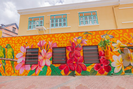 A view of the facade of an old building in Downtown Willemstad, Curacao, adorned with bright pink-red-orange flowers. Willemstad.のeditorial素材