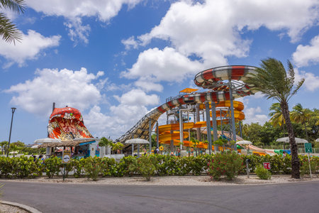 Scenic view of the hotel's water park featuring water slides, set against a backdrop of a blue sky with fluffy white clouds.のeditorial素材