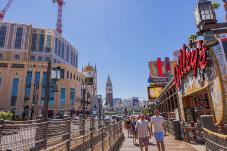 Beautiful view of people strolling along the Las Vegas Strip near the Treasure Island casino hotel on a clear and sunny day. Las Vegas. USA.のeditorial素材