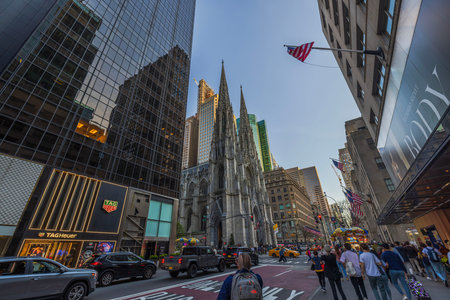 View of the Gothic architecture of St. Patrick's Cathedral in New York City amidst the skyscrapers...