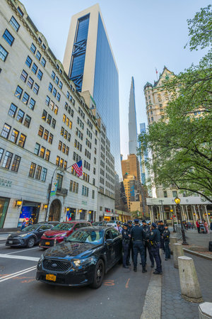 Observing a police team stationed on 5th Ave in NYC, their patrol vehicle marking their presence in...