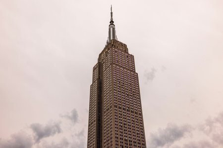 Stunning view of the Empire State Building towering above the New York City skyline against a...