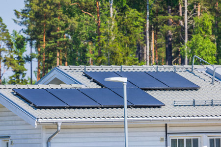 Beautiful view of a villa roof with solar panels in a village. Sweden.