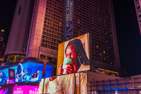 Close-up view of Times Square at night, featuring illuminated billboards and advertisements. New York. USA.のeditorial素材