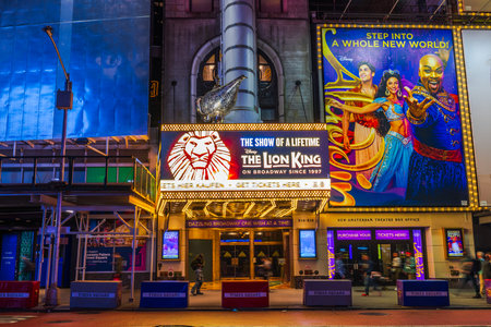View of Times Square in Manhattan with Music Theater hosting The Lion King musical and illuminated advertising billboards. New York. USA.のeditorial素材