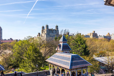 View of historic Central Park pavilion with New York City skyline on clear sunny spring day. New York. USA.のeditorial素材