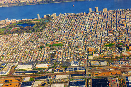 Aerial view of densely populated urban area with residential buildings, green parks and Hudson River in background. New Jersey, . USA.の写真素材
