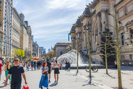 Visitors walking near Metropolitan Museum of Art entrance on bright spring day with fountains and bare trees. New York. USA.のeditorial素材