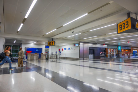 Delta Airlines boarding gates B32 and B33 at Newark Liberty International Airport terminal with woman running to catch her flight. New Jersey, USA.のeditorial素材