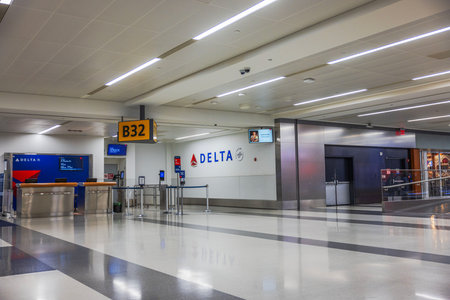 Delta Airlines gate B32 interior at Newark Liberty International Airport with check-in counters and empty boarding area. New Jersey, USA.のeditorial素材