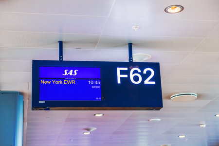 Gate sign F62 for SAS flight SK903 departing at 10:45 to New York EWR (Newark Liberty International Airport). Stockholm, Sweden.のeditorial素材
