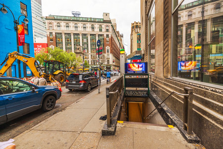 Entrance to New York City subway station on 34th Street with urban street scene, vehicles, construction, and pedestrians. New York. USA.のeditorial素材