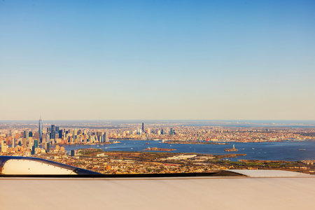 Aerial view of Manhattan skyline with Statue of Liberty and Hudson River from airplane window. USA.の写真素材