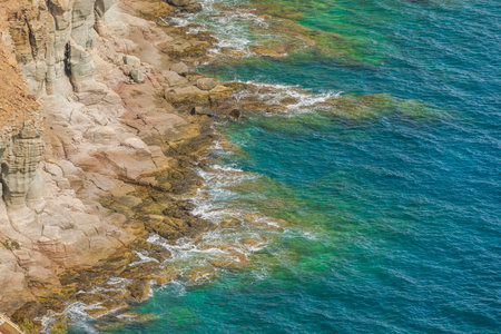 Rocky coastline of Gran Canaria with turquoise waves Atlantic ocean crashing against rugged cliffs.の写真素材