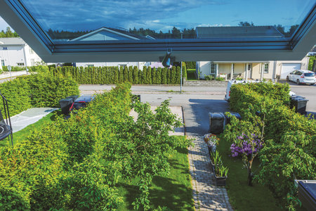 Top view through open window of driveway in villa community with gravel area prepared for asphalt paving designed for second car and neatly front garden. Sweden.の写真素材
