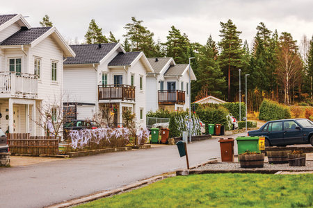 Beautiful view of row of white villas decorated for Halloween with spider webs on fences and autumn trees around.の写真素材
